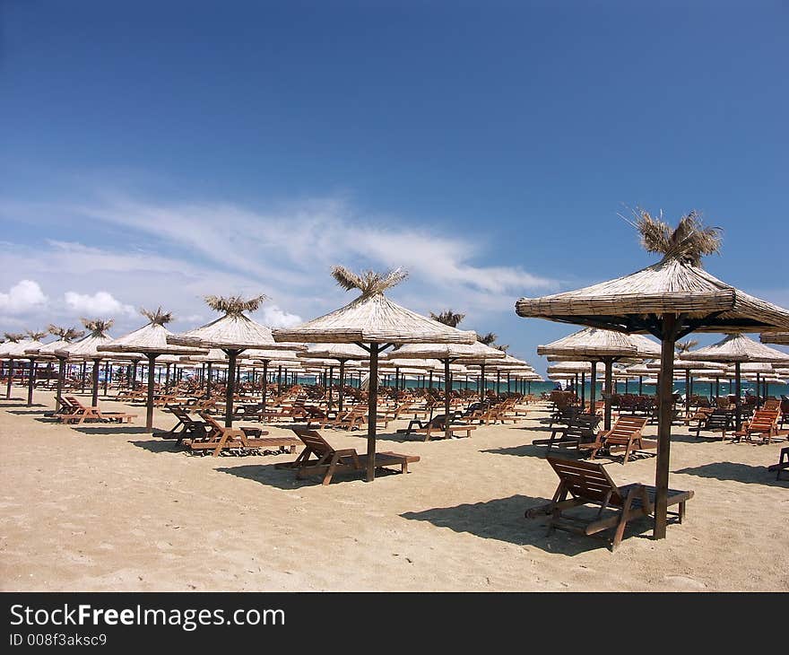 Straw shade umbrellas on a beach. Straw shade umbrellas on a beach