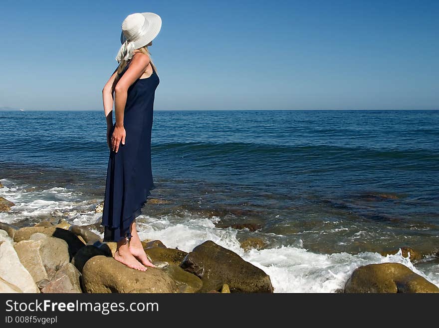 The girl in a dress on stones. The girl in a dress on stones