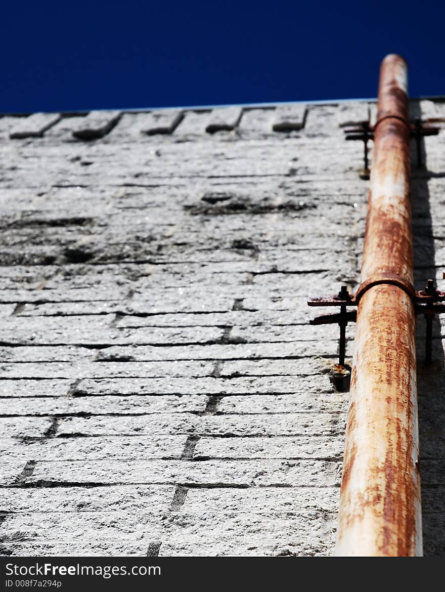 Rusty pipe on a white wall background. Rusty pipe on a white wall background