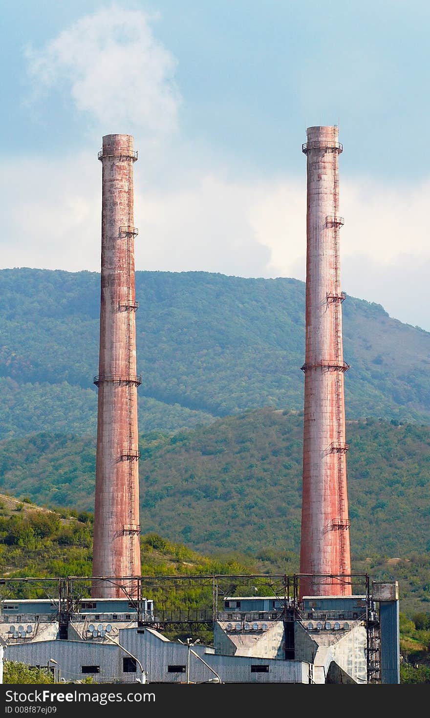 Two very similar factory chimney of cement works. Two very similar factory chimney of cement works