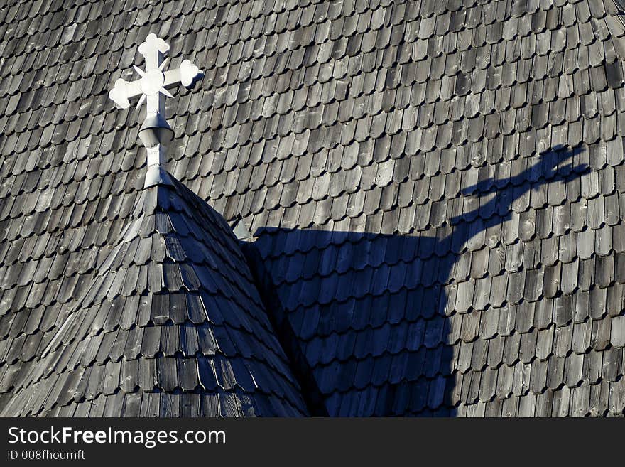 Wooden church roof with white cross