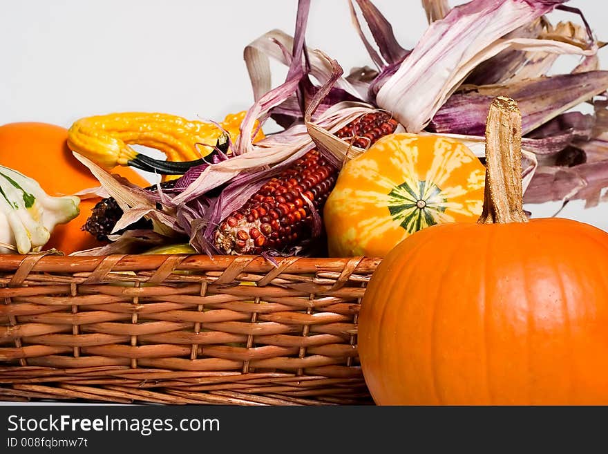 Twigs basket full of pumpkins and corn ready for Halloween. Twigs basket full of pumpkins and corn ready for Halloween