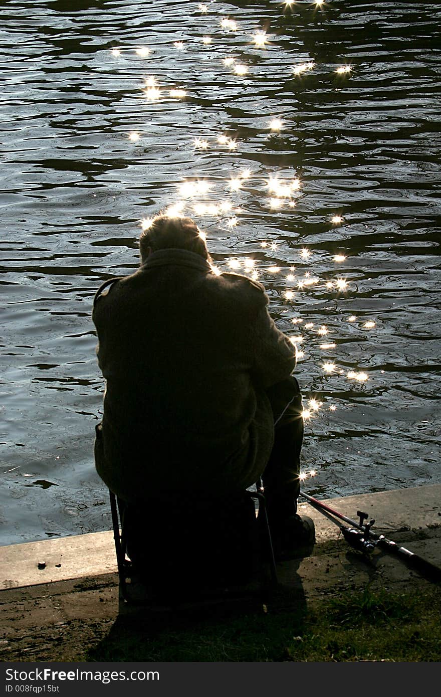 Silhouette of an angler at the bank of the river IJssel in Zutphen (the Netherlands). Silhouette of an angler at the bank of the river IJssel in Zutphen (the Netherlands).