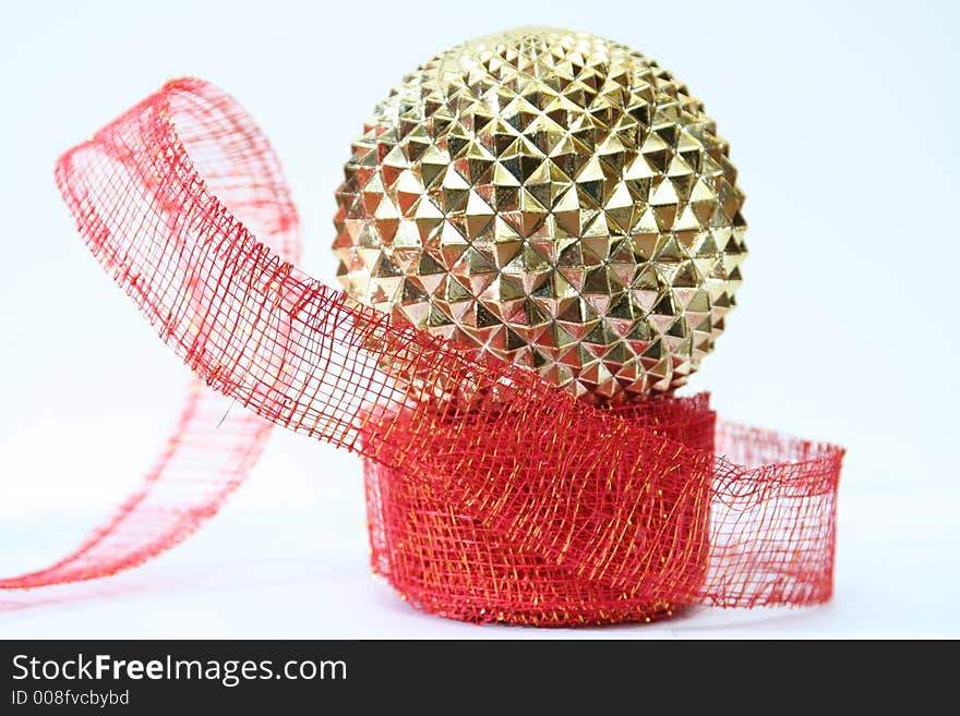 Gold ornament on red ribbon white background. Gold ornament on red ribbon white background