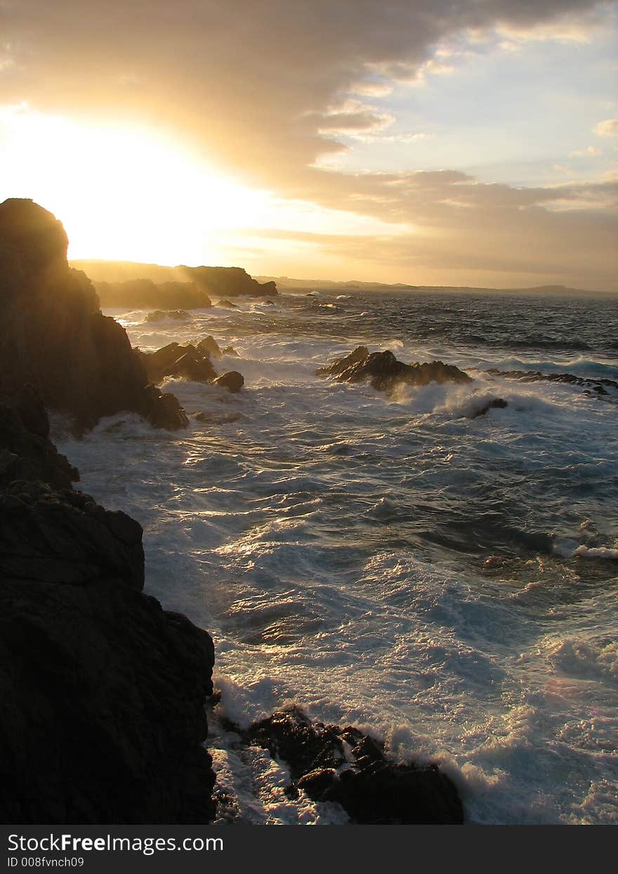 Orange sun set with rocks and waves. Orange sun set with rocks and waves