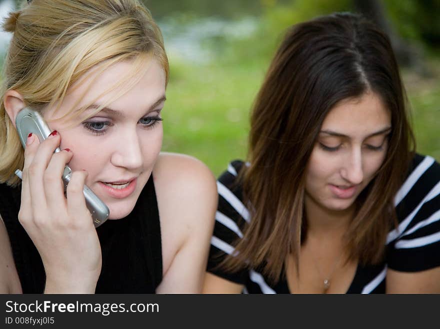 Friends on Cell Phone together (Beautiful Young Blonde and Brune