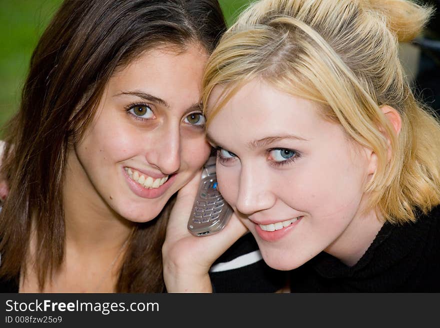 Friends on Cell Phone together (Beautiful Young Blonde and Brune