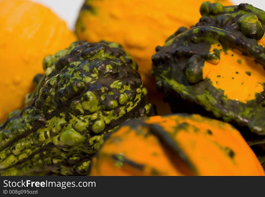 A bunch of colorful, bumpy looking, fall gourds.