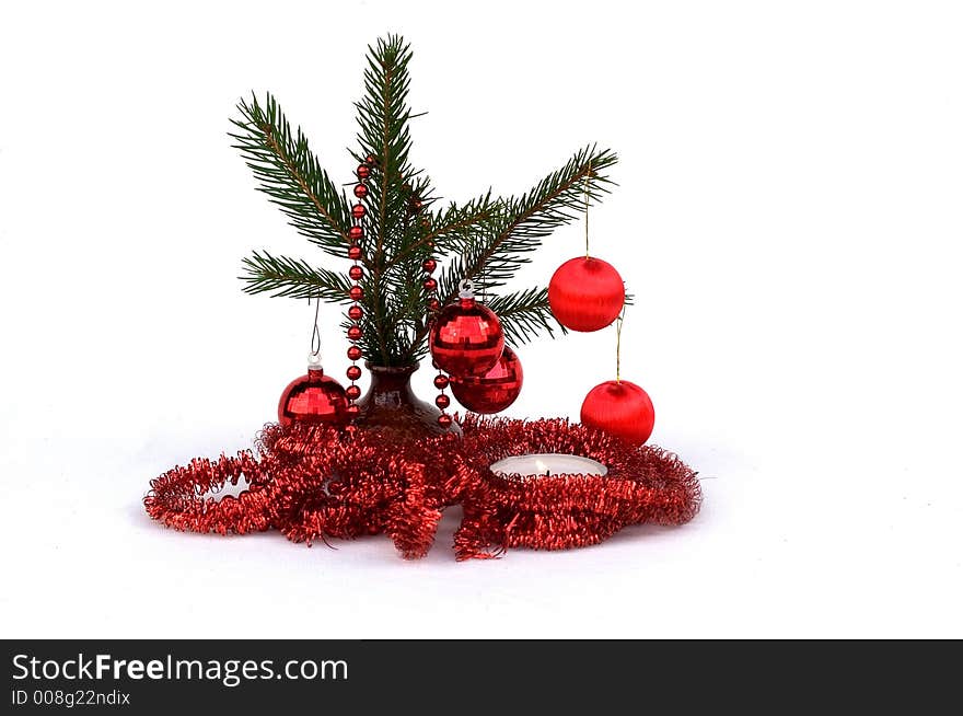 Pine branch with Christmas ornaments isolated on a white background. Pine branch with Christmas ornaments isolated on a white background