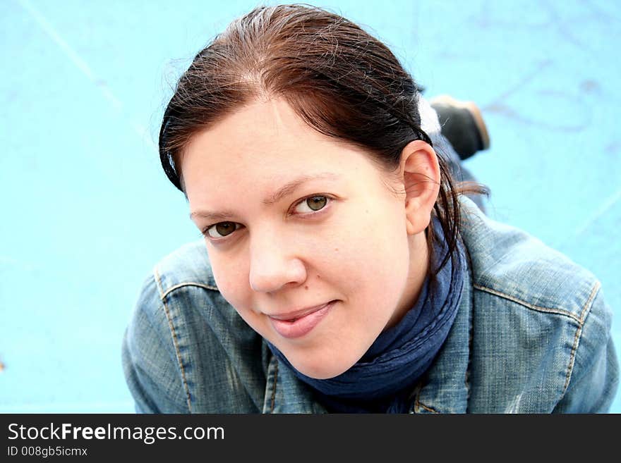 Young woman portrait outdoor with blue background