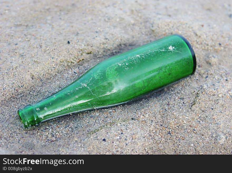 Green bottle washed up on the beach