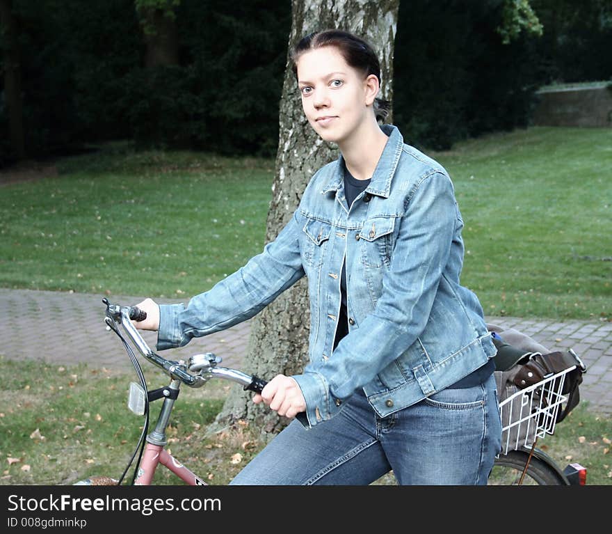 Young woman with a bicycle in the forest. Young woman with a bicycle in the forest