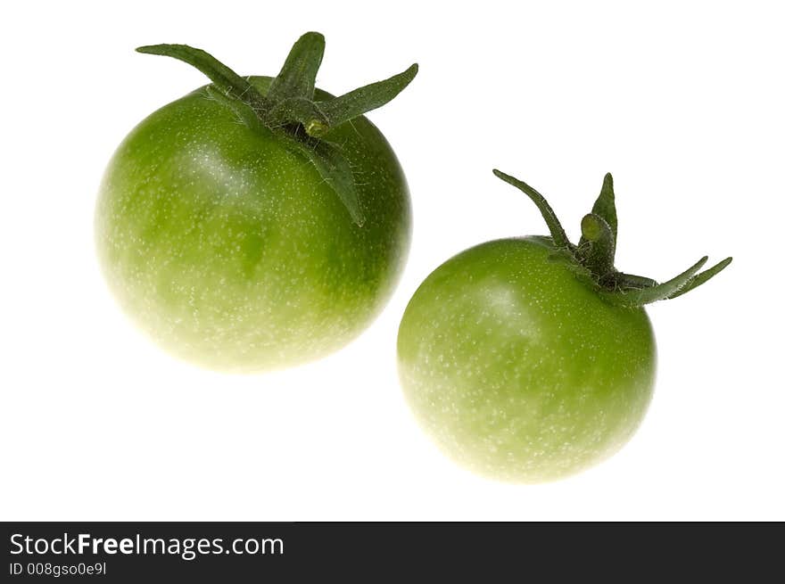 Two green tomato on the white. Two green tomato on the white