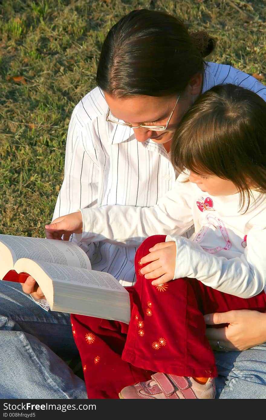 Digital photo of a mother and her daughter reading a book. Digital photo of a mother and her daughter reading a book.