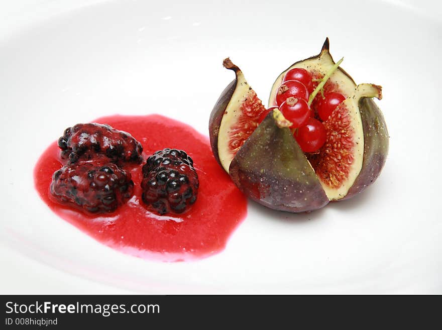 Freshly poached fig with mulberry fruit and sauce appetizer course. Freshly poached fig with mulberry fruit and sauce appetizer course