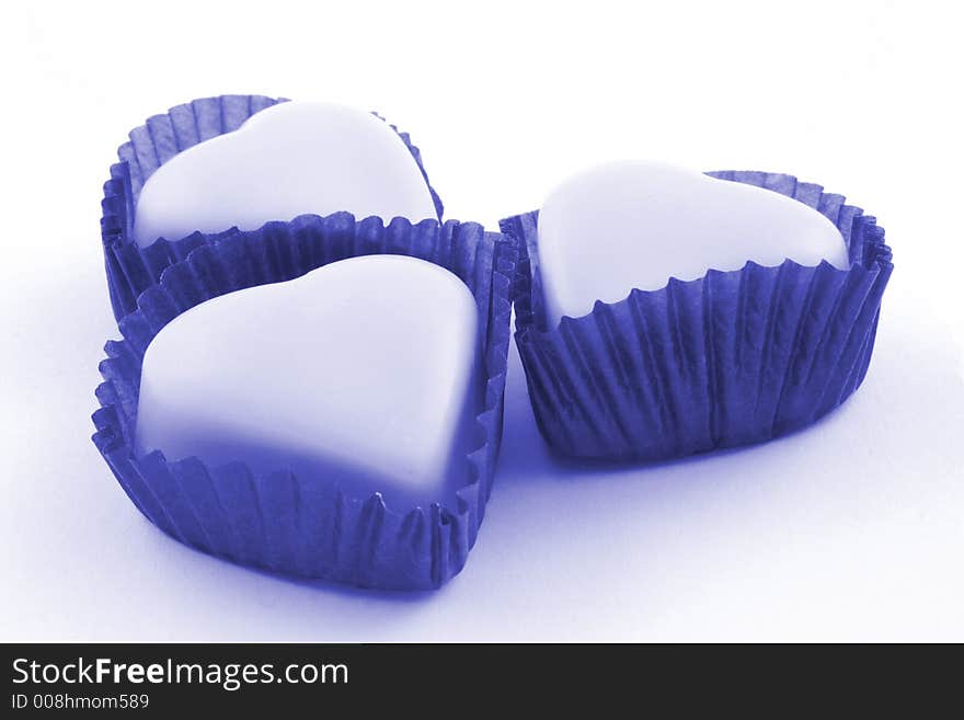 Pink love heart chocolates on a white background