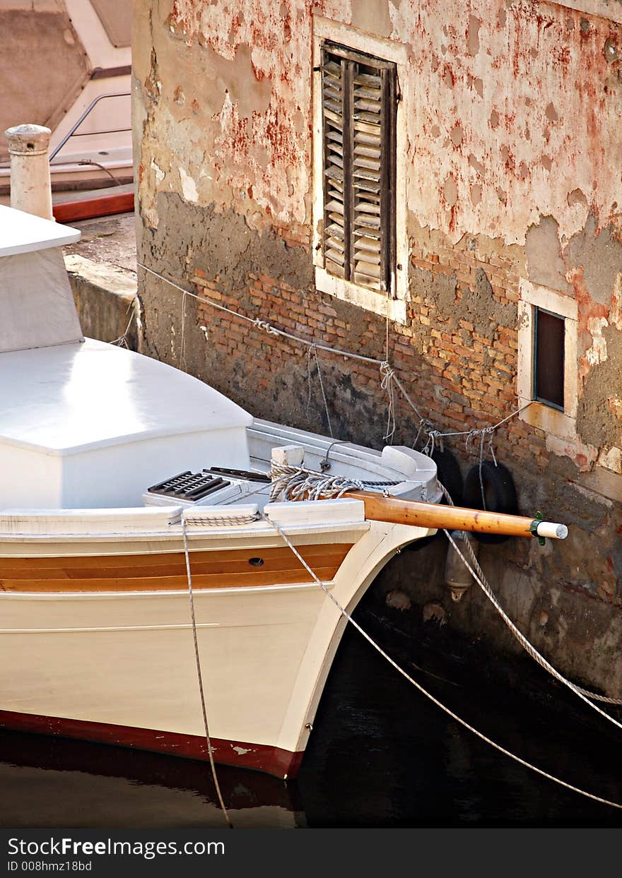 Detail of a vessel in front of old house. Detail of a vessel in front of old house