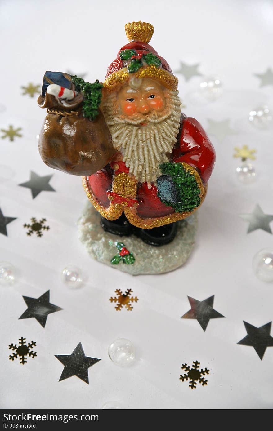 Santa Claus with presents, in front of a white background. Lighted with Dedo spots.