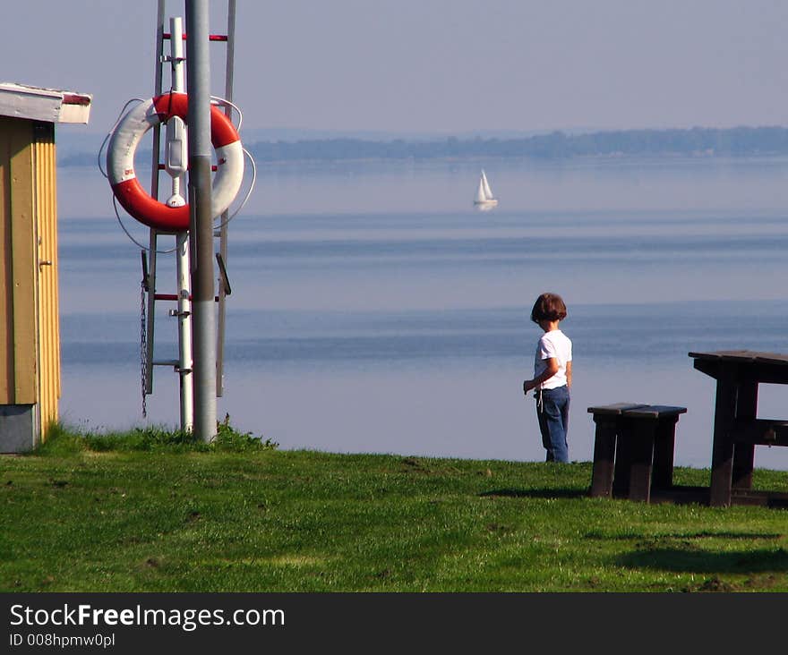 Litte girl is watching on the lake. Litte girl is watching on the lake