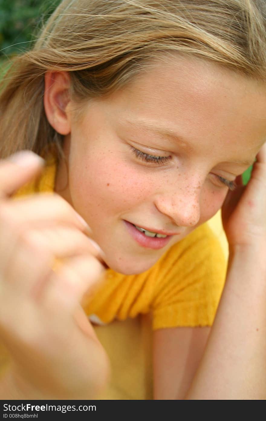 Close up of young girl brushing her hair with her hand. Close up of young girl brushing her hair with her hand