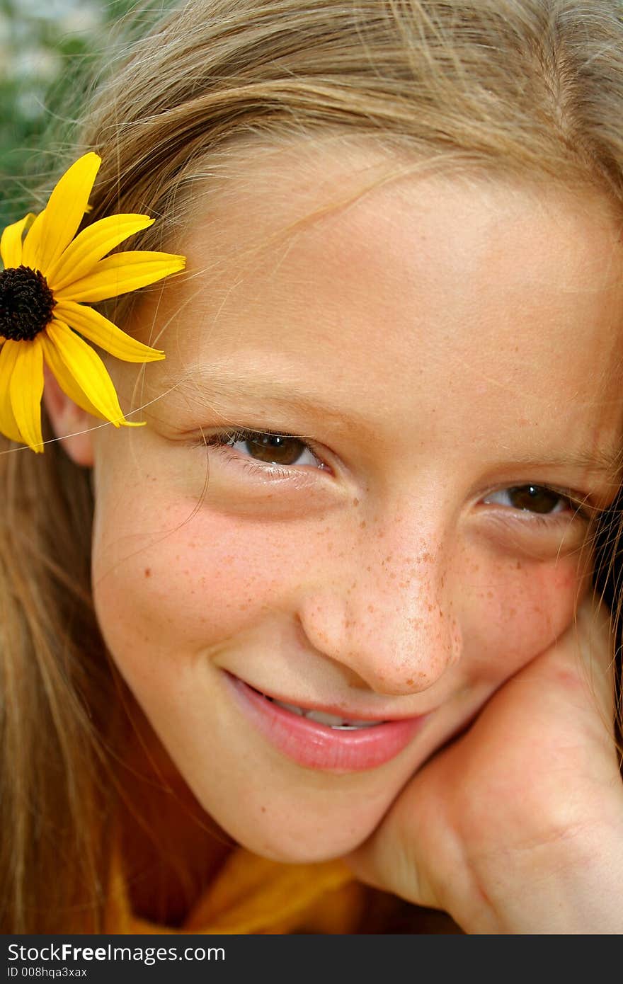 Close up of young girl with flower in hair. Close up of young girl with flower in hair