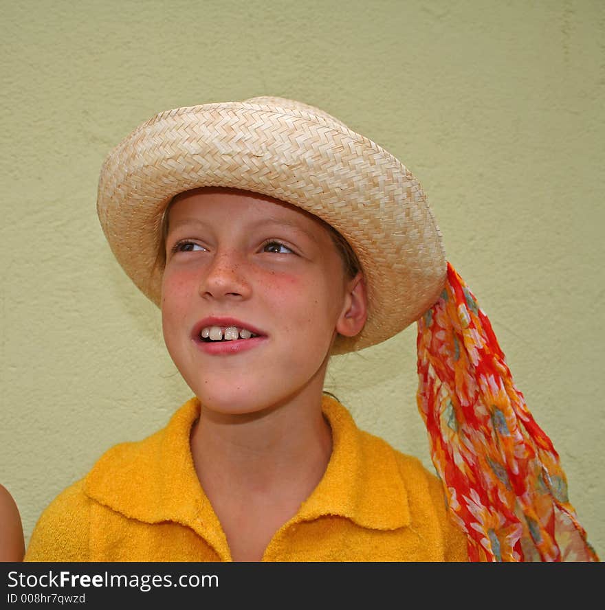 Young girl with hat smiling with teeth