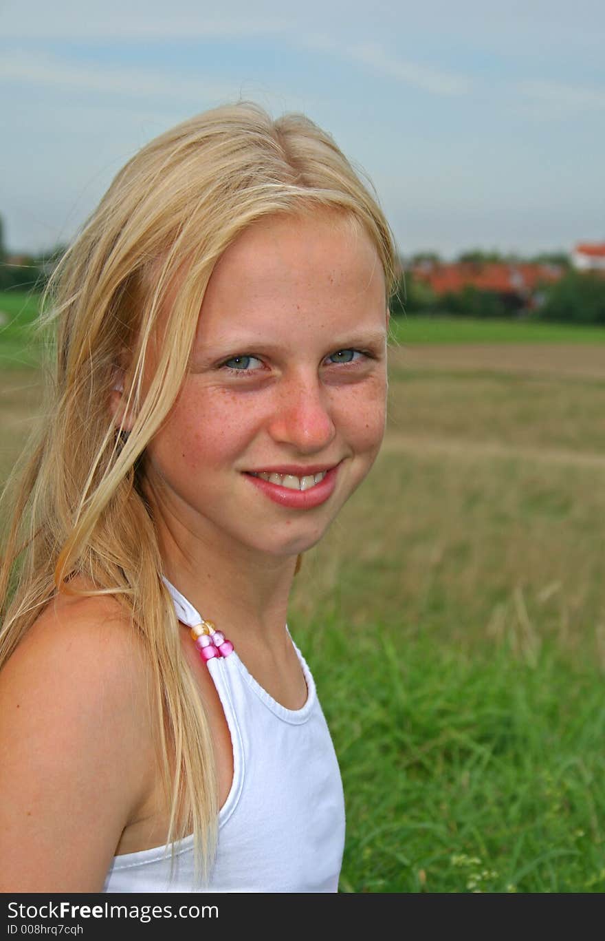 Portrait of standing girl in field