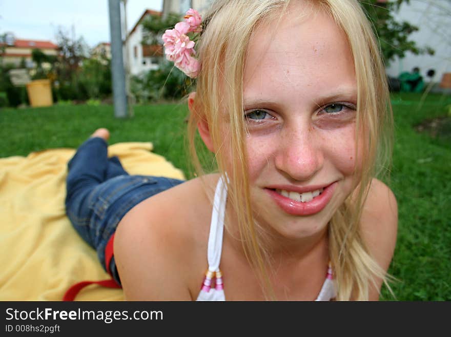 Young girl laying on blanket in garden