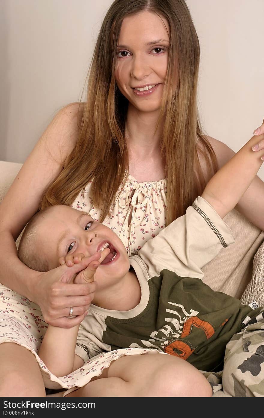 Young blond woman playing with a small boy. Young blond woman playing with a small boy