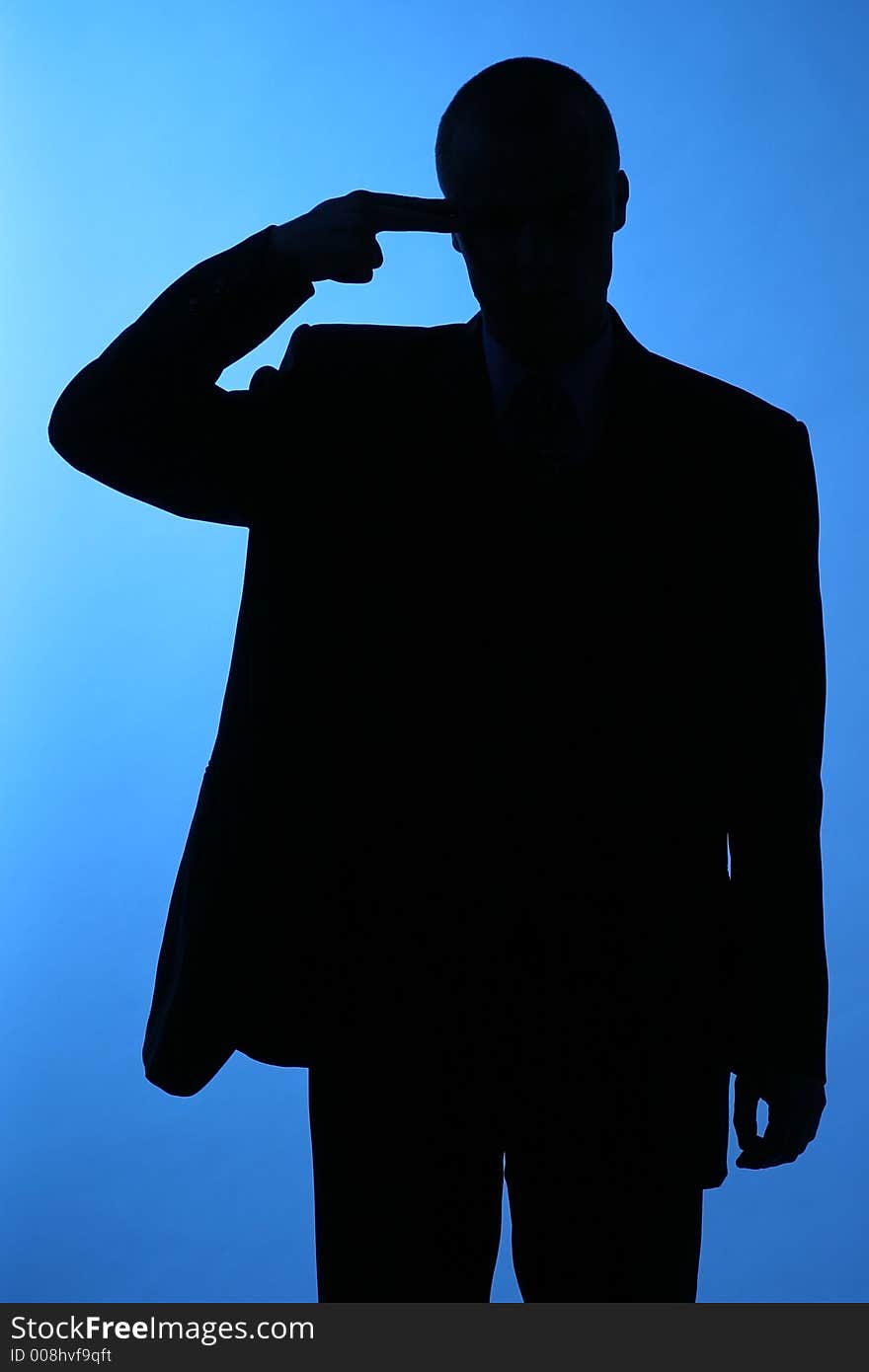 Elegant man, businesman in  a suit pointing to his temple-sillhuette