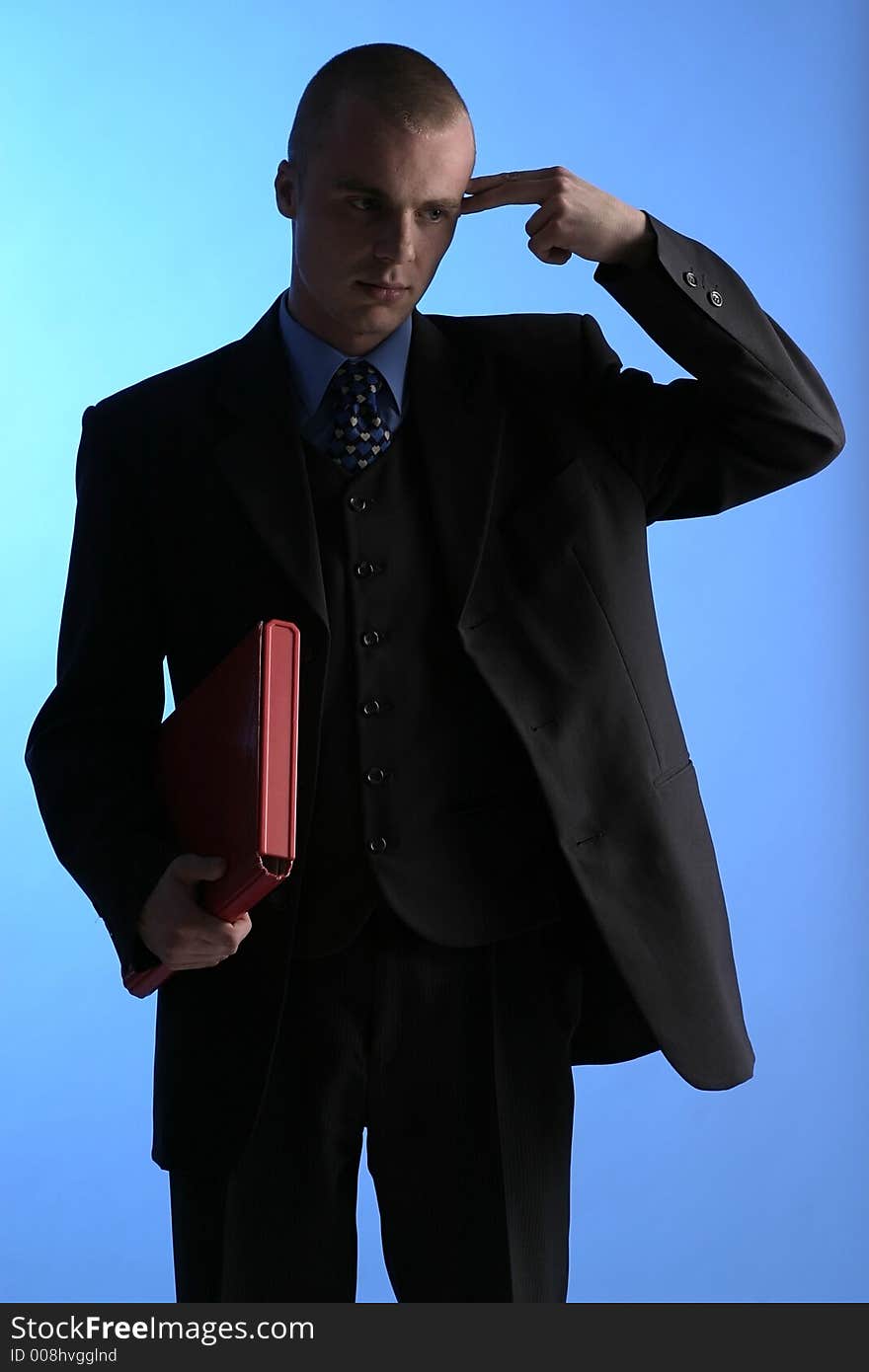 Elegant man, businesman in a suit pointing to his temple