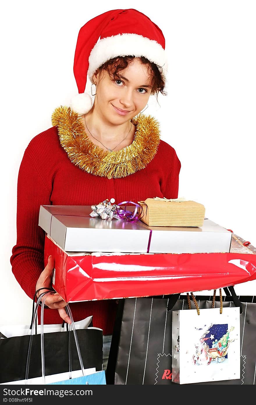 Young woman in  a red and white santa fancy hat with presents. Young woman in  a red and white santa fancy hat with presents