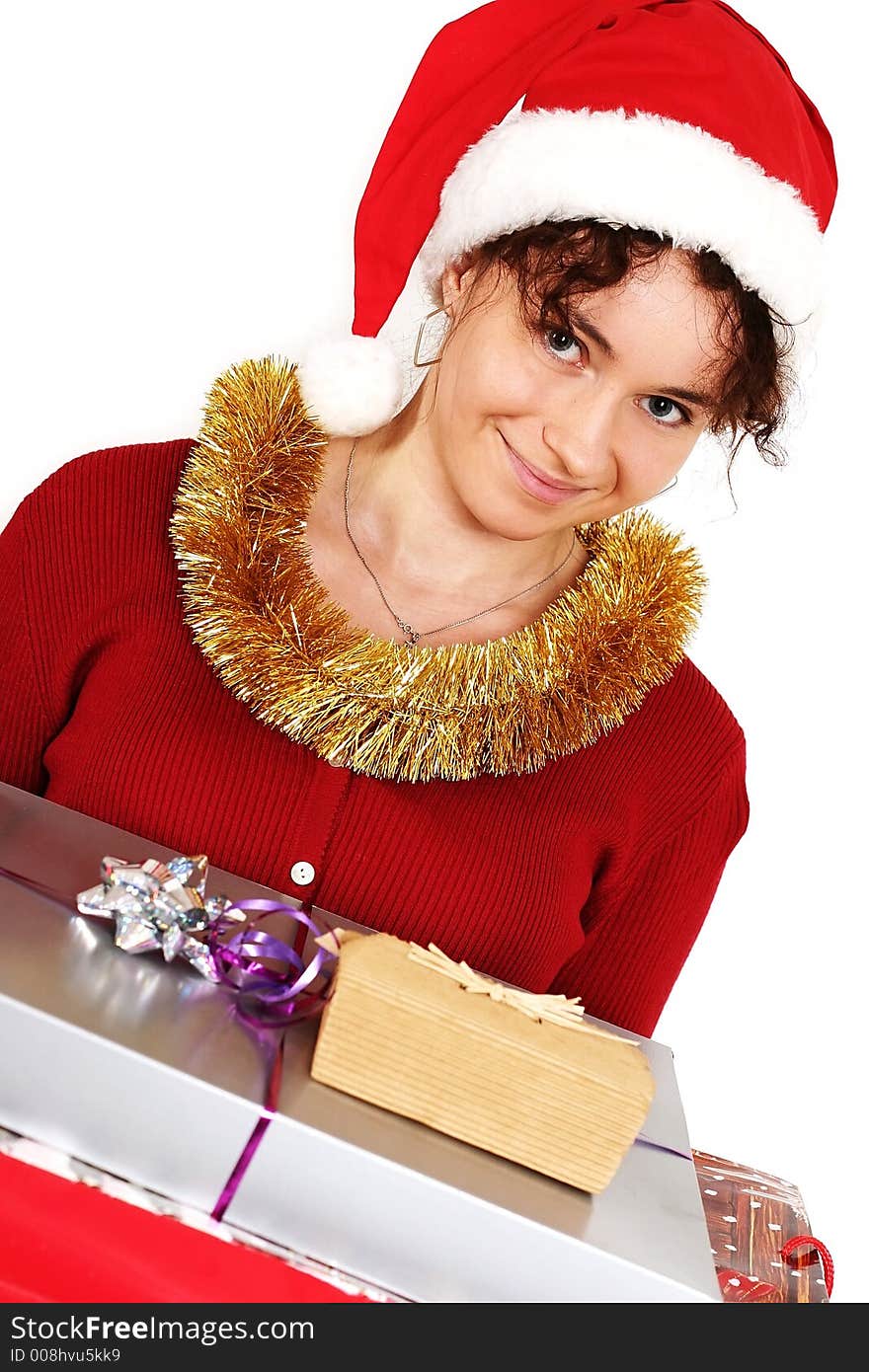 Young woman in a red and white santa fancy hat with presents. Young woman in a red and white santa fancy hat with presents