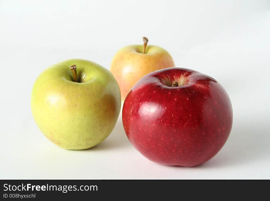 Juicy fresh apples separately from a background with drops of water on a leather