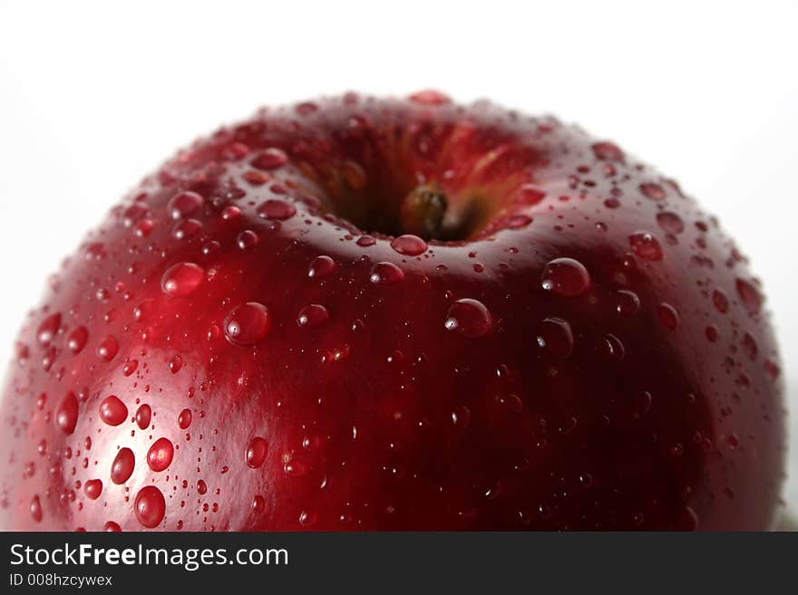 Juicy fresh apples separately from a background with drops of water on a leather