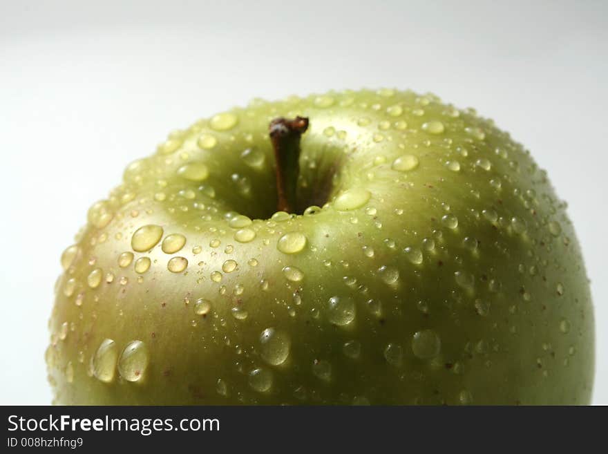 Juicy fresh apples separately from a background with drops of water on a leather