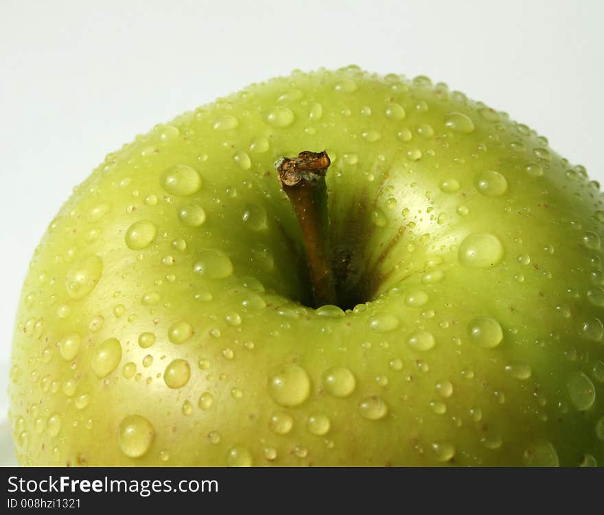 Juicy fresh apples separately from a background with drops of water on a leather