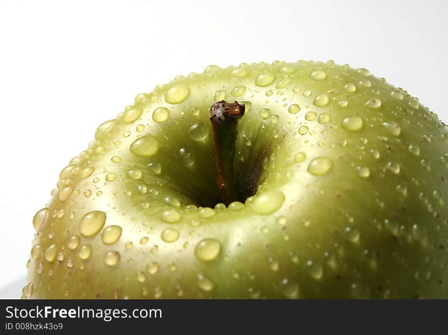 Juicy fresh apples separately from a background with drops of water on a leather