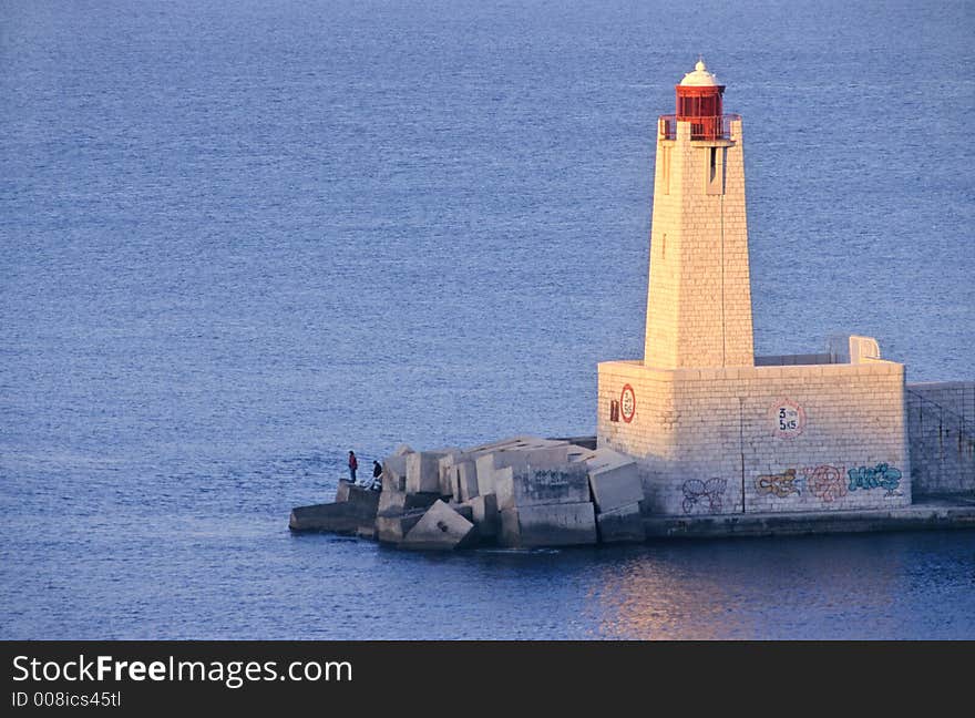 Beacon at sunrise in the entrance of Nice port in french riviera, europe. Beacon at sunrise in the entrance of Nice port in french riviera, europe