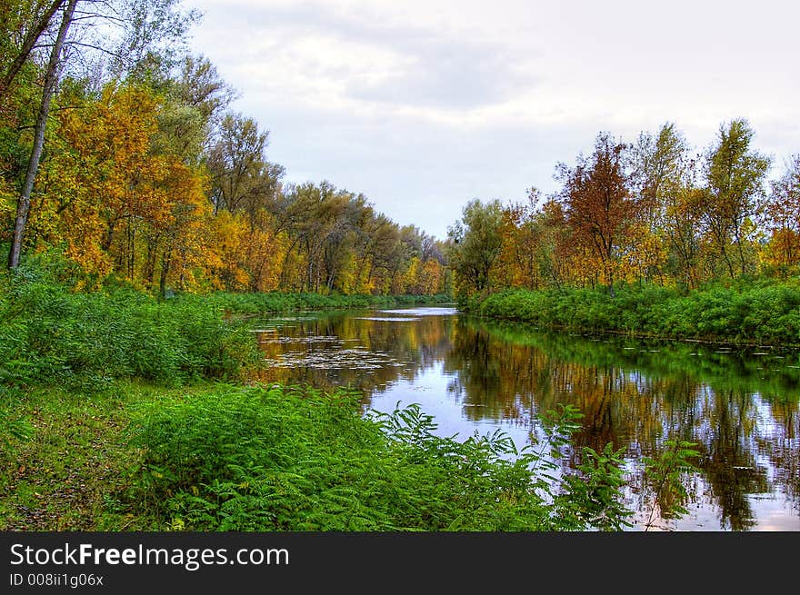 Picturesque autumn landscape of river and bright trees. Picturesque autumn landscape of river and bright trees