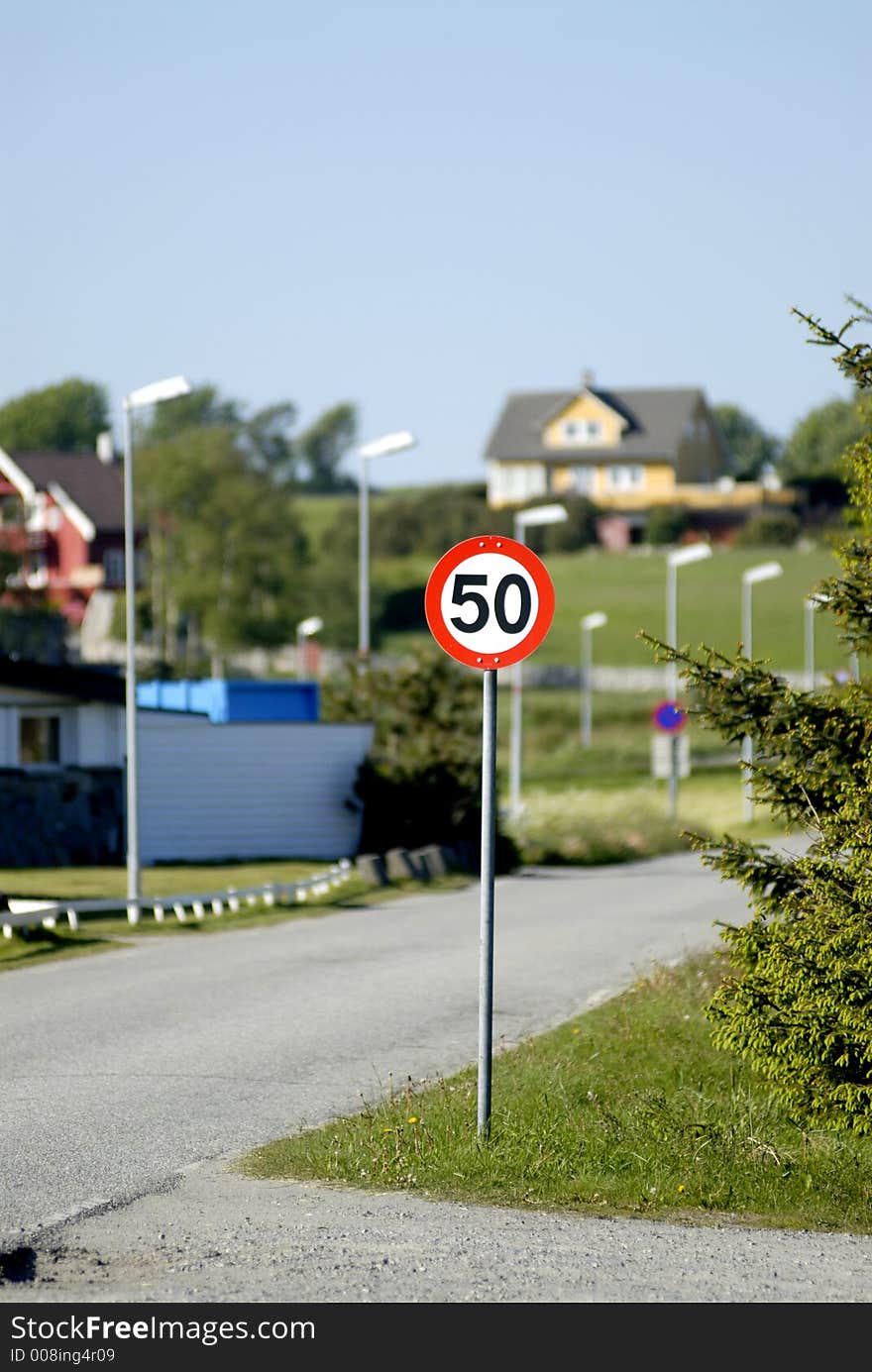 Road sign with buildings on background