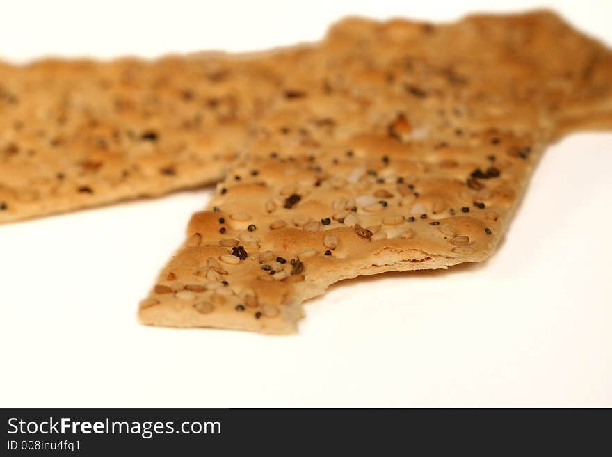 Close up of Seeded flat crackers with bite taken out in corner