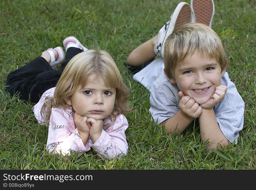 Two kids relaxing on grass. Two kids relaxing on grass