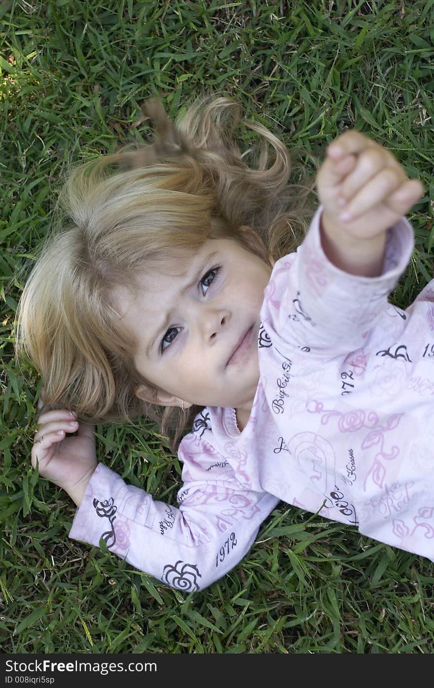 Young girl on grass with arm in air