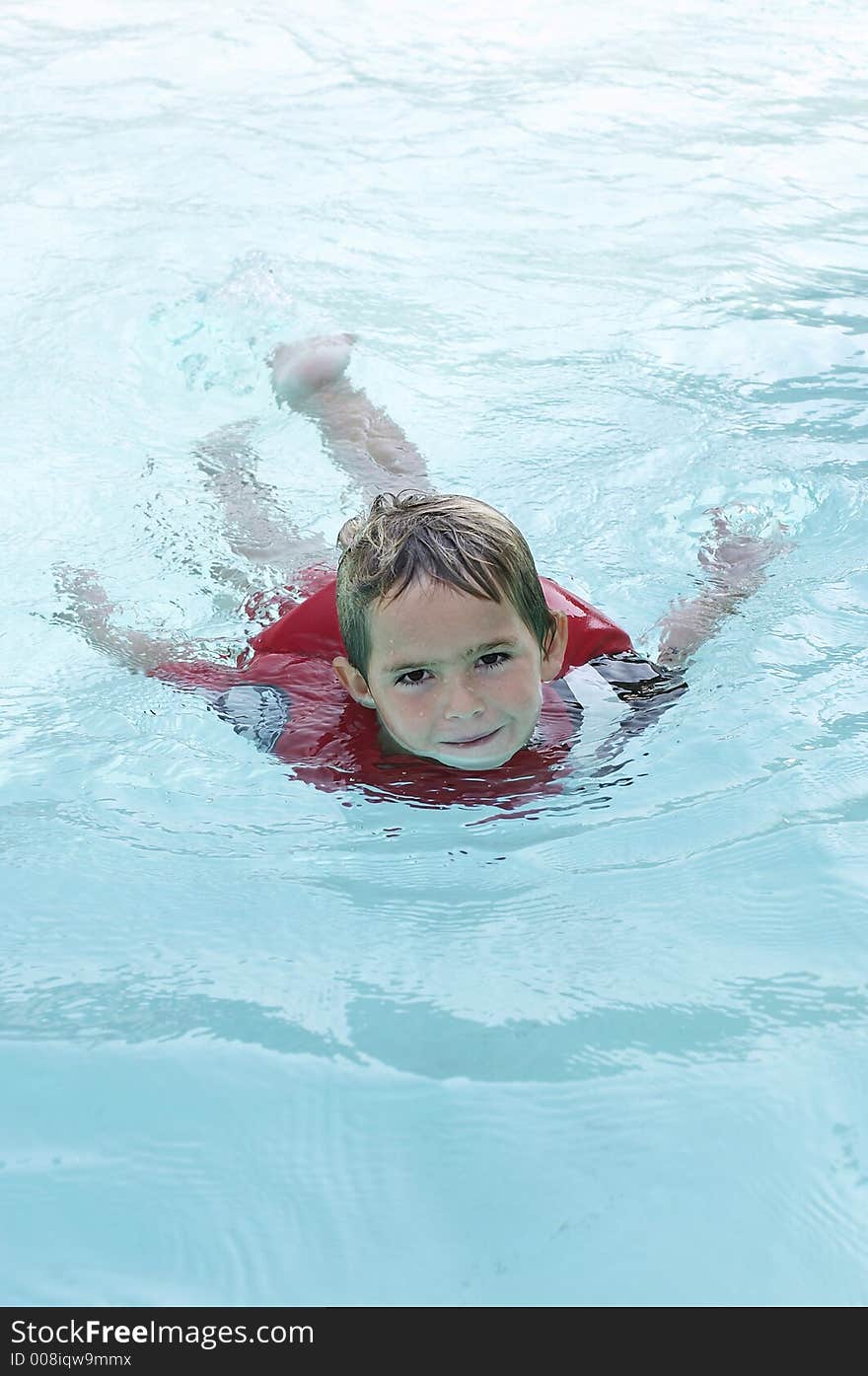 Young boy swimming in pool