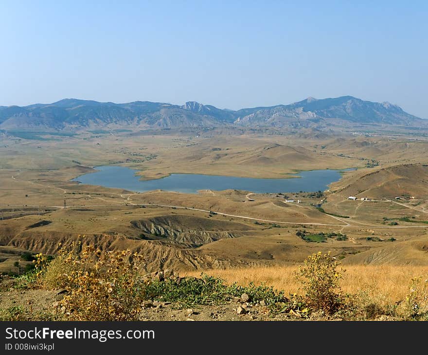 Lake in valley, far mountains