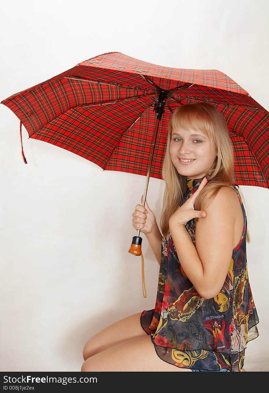 Young woman with umbrella on white