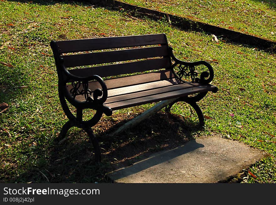 A wooden bench by the park