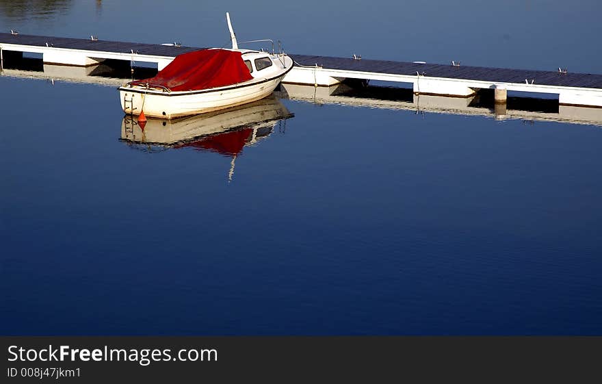 Lake mole with clear blue ad peacefully water and boat