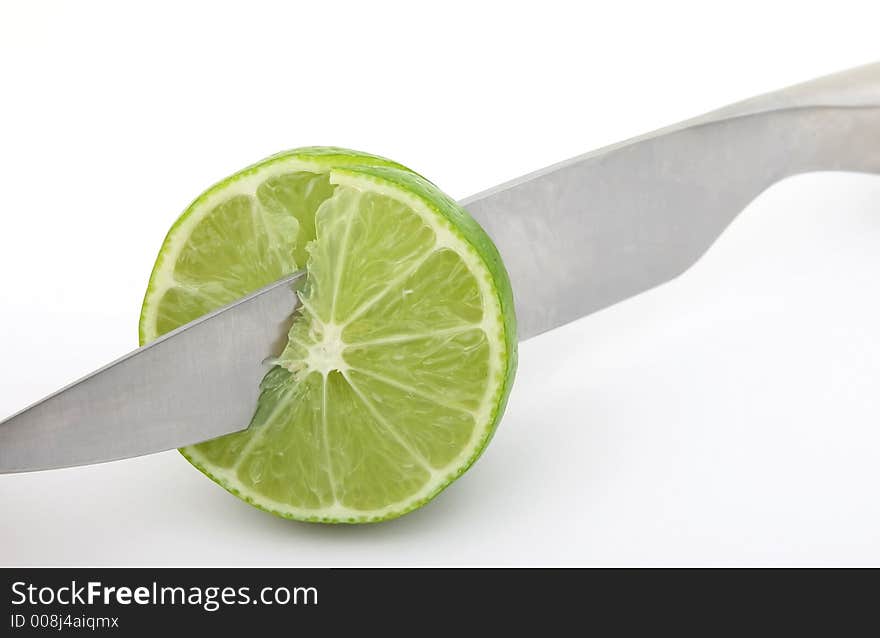 Fresh fruit, a tropical green lemon macro closeup, isolated on white, close-up with copyspace. Fresh fruit, a tropical green lemon macro closeup, isolated on white, close-up with copyspace